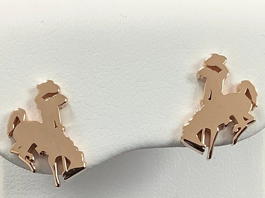 A pair of small horse and cowboy stud earrings in a warm 14KR gold high polish finish