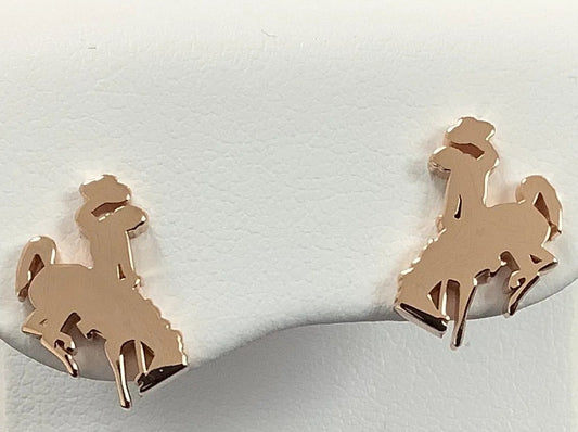 A pair of small horse and cowboy stud earrings in a warm 14KR gold high polish finish
